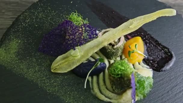 Slow zoom in at trendy decorated fish rolls spinning around on black plate — Stock Video