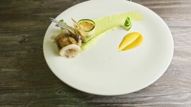 restaurant plate with finely decorated fish dish spinning around
