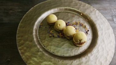 executive decorated four spherical sponge biscuits spinning on around plate