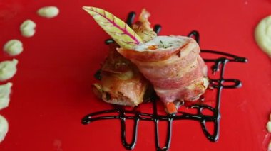 slow zoom out from tasty meatloaf baked in bacon rotates on square plate