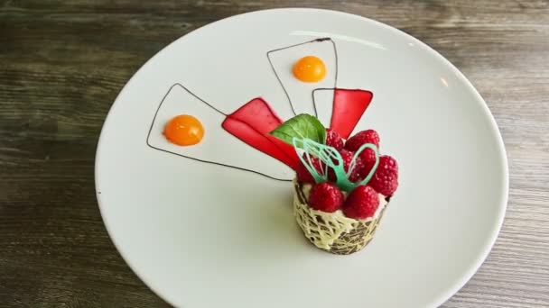 Tasty chocolate cream raspberry dessert spin around on white plate — Αρχείο Βίντεο