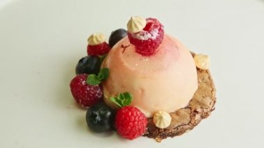 top view closeup dessert trendy decorated with berries rotates on plate