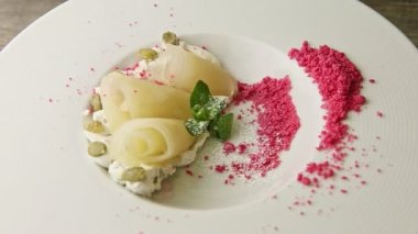 slow zoom out from finely decorated restaurant dessert spinning around on plate