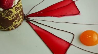 macro view of tasty raspberry dessert spin around on white plate