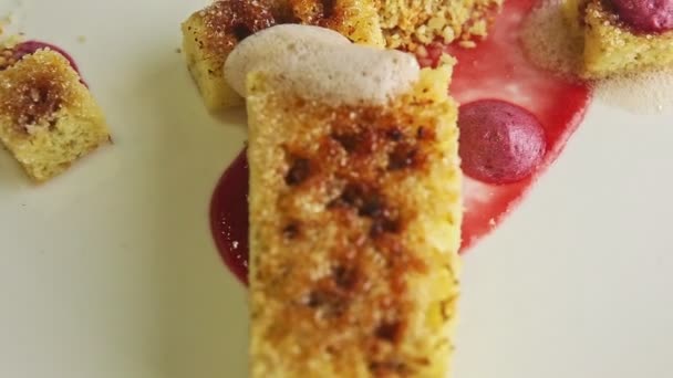 시럽 으로 현대식으로 재단 한 얇게 썬 스폰지 케이크 는 흰 접시에서 회전한다 — 비디오