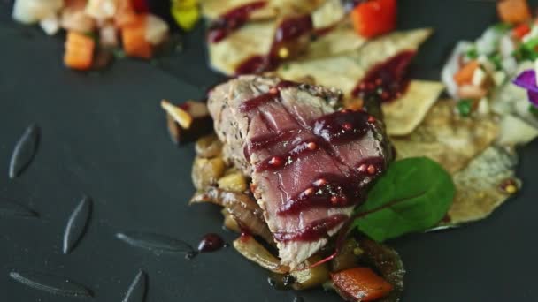 Panorama zbliżenie na kawałki mięsa ozdobione pikantnym sosem i sałatką warzywną — Wideo stockowe