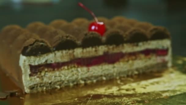 Closeup focus in at half of original creamy chocolate cake with fruit jelly interlayer — Stock Video