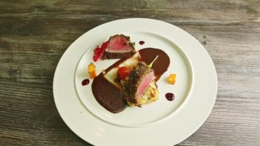 top view on exquisite decorated semi-raw fried meat pieces with sauce