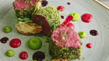 zoom out from fried meat pieces with assorted sauces rotates on plate
