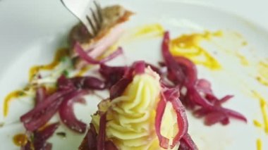 closeup human hands take away small slice from meat steak by fork