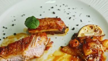 closeup panorama on half-eaten tasty grilled meat ribs with garnish