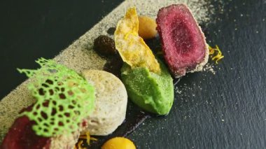 closeup panorama on finely decorated roasted meat with assorted purees and sauces