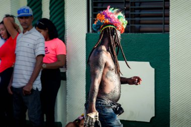 Concepcion De La Vega, DOMINICAN REPUBLIC - FEBRUARY 09, 2020: native man in strange costume walks by city street at dominican annual carnival on February 9 in Concepcion De La Vega