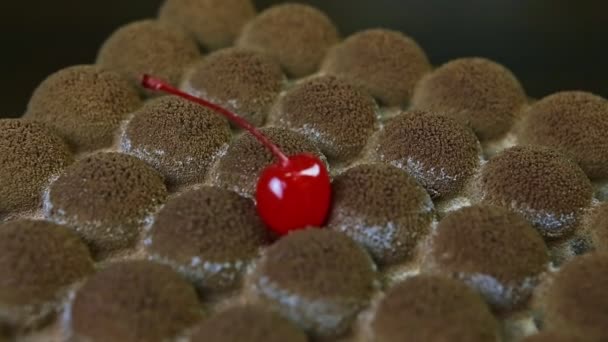 Panorama de primer plano en la superficie moderna pastel de chocolate decorado con cereza — Vídeos de Stock