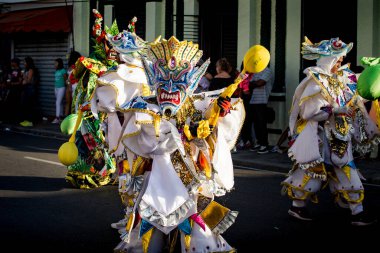 Concepcion De La Vega, DOMINICAN REPUBLIC - FEBRUARY 09, 2020: adult person in sparkling costume poses for photo on dominican annual carnival on February 9 in Concepcion De La Vega
