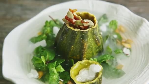 Slow zoom out from pumpkin dessert decorated with smoke rotates on white plate — Stock Video