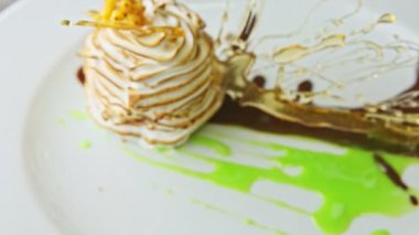 zoom out from exclusive swan-shaped dessert spinning around on plate