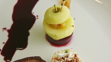 closeup trendy decorated grilled sliced duck and garnish rotates on plate