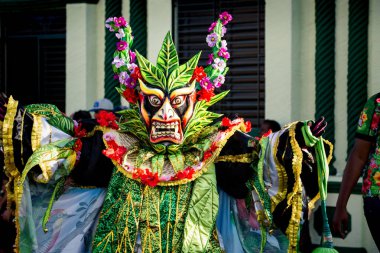 Concepcion De La Vega, DOMINICAN REPUBLIC - FEBRUARY 09, 2020: closeup man in extraordinary bright costume poses for photo on dominican carnival on February 9 in Concepcion De La Vega