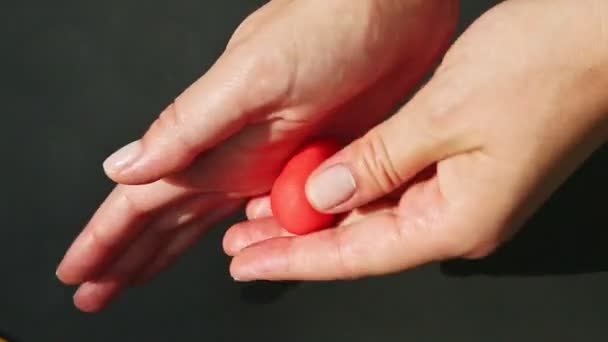 Top view closeup hands make heart shaped candy from red marzipan mass — Stock Video