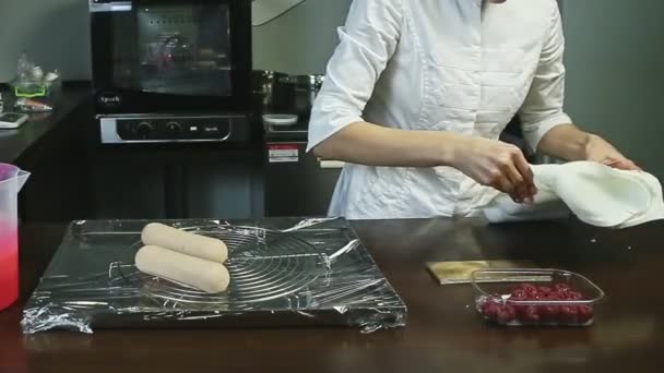 Confectioner takes out frozen oval cake forms and puts on metal stand — Stock Video