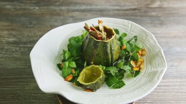 Exclusive pumpkin dessert decorated with fresh mint rotates on white plate — Stock Video
