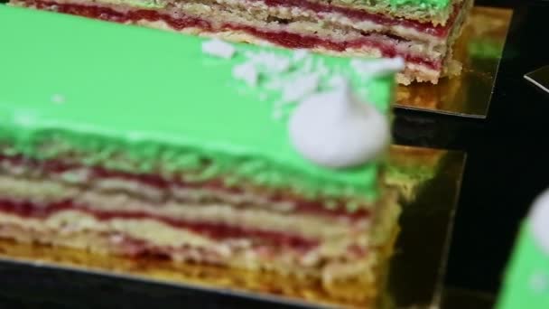 Detailní panorama na zeleném proskleném vrstveném dortu porce podávané na černém podnosu — Stock video