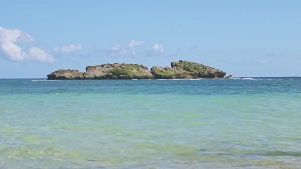 Nubes esponjosas blancas sobre el océano azul con olas y playa de arena dorada — Vídeos de Stock