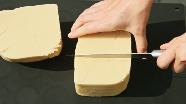 Top view woman hands slice by big knife large cubes of white marzipan mass — Stock Video