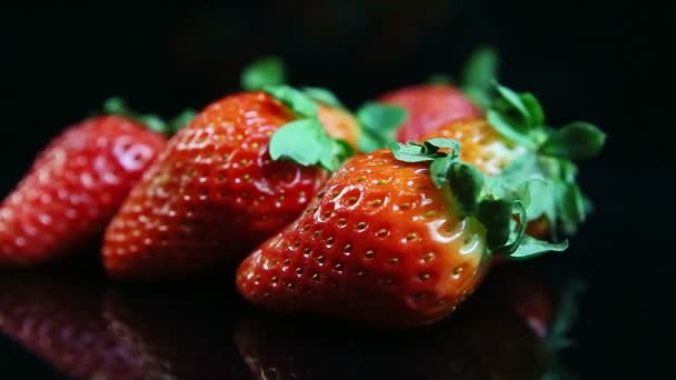 Panorama de primer plano en grupo pequeño de fresas rojas jugosas maduras frescas enteras — Vídeos de Stock