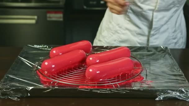 Confectioner White Uniform Takes One Four Pink Glazed Oval Dessert — Stock Video