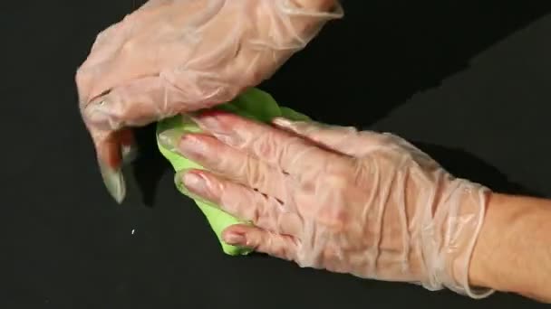 Top view female hands knead big piece of green marzipan mass and form ball — Stock Video