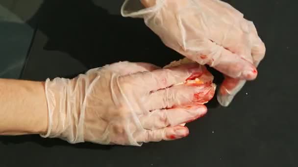 Top view on woman hands knead big piece of white marzipan with orange colorant — Stock Video