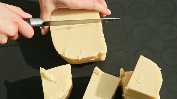 Top view female hands slice by big knife small cubes of white marzipan mass — Stock Video