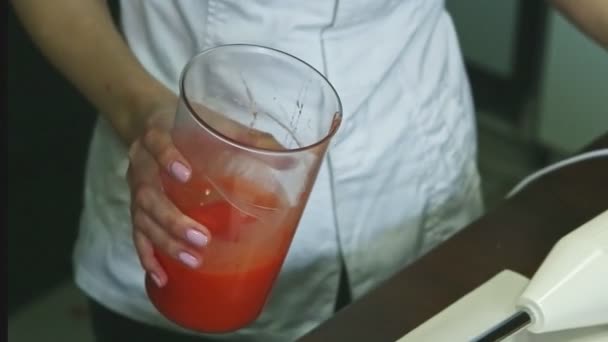 大きなバケツの中で赤い自家製液体釉薬を混ぜ合わせた菓子 — ストック動画