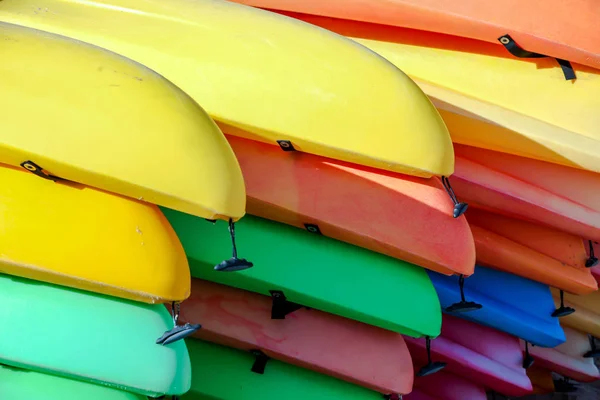 Background from stacked colorful kayaks — Stock Photo, Image