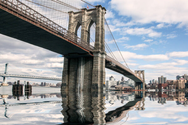 NEW YORK CITY, NY, USA - APRIL 8,2016: New York City view with Brooklyn bridge Skyline at nice day with artificial water reflection