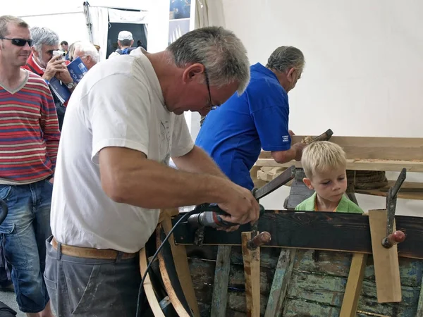 Brest, França - 14 de julho de 2008: Construtores navais tradicionais croatas estão trabalhando na restauração de um velho barco de madeira durante o festival marítimo — Fotografia de Stock