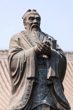 Bronze statue of Confucius in traditional pose clipart