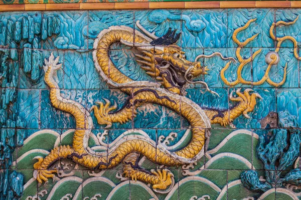 Golden dragon with white crest floating in waves — Stock Photo, Image