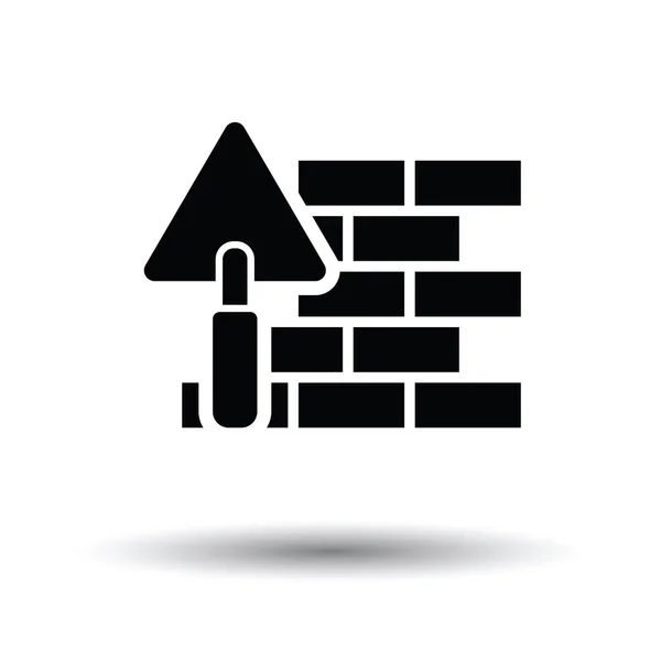 Icon of brick wall with trowel — Stock Vector