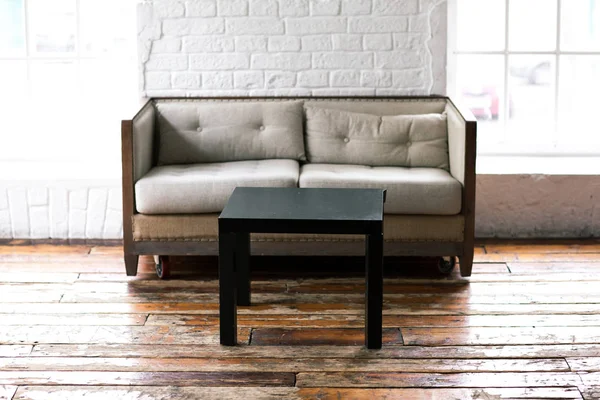 Loft interior with brick wall and coffee table — Stock Photo, Image