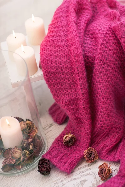 Cozy wool winter accessory. Warm sweaters candle and wood tray — Stock Photo, Image