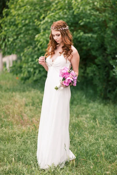 Bela noiva em vestido branco no jardim — Fotografia de Stock