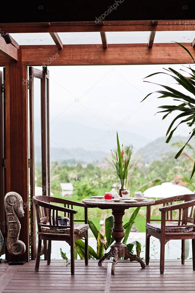 Yummy and healthy breakfast on terrace on wood table with beautiful view