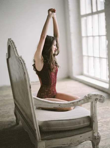 Joven hermosa morena posando en ropa interior de encaje inferior en sala de luz —  Fotos de Stock