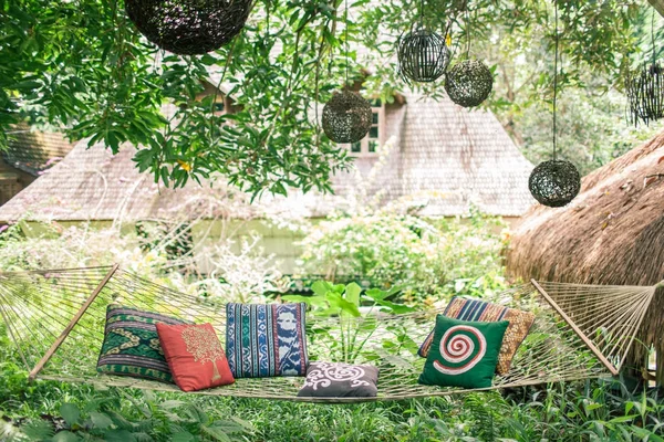 A hammock with Pillows in a secluded tropical green place. Summe — Stock Photo, Image