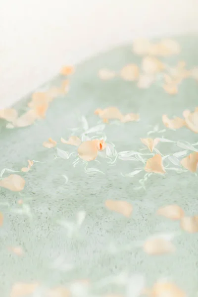 Bright Bathroom at Home. Bath with Flower Petals and Salt. Tray over the Bath with Orange Juice, Notepad and Candles.