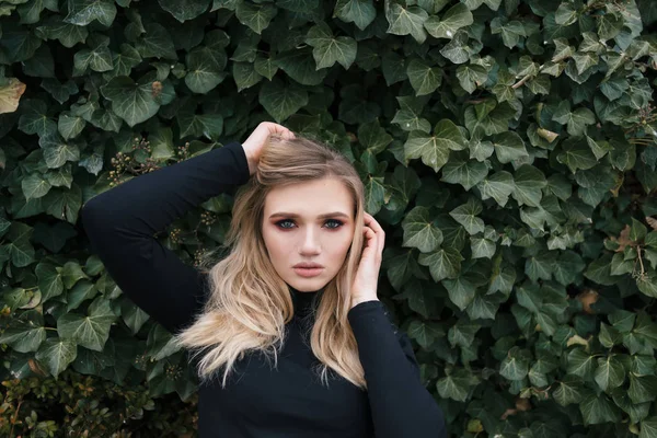 Blonde posing for a photo and raising her hair — Stock Photo, Image