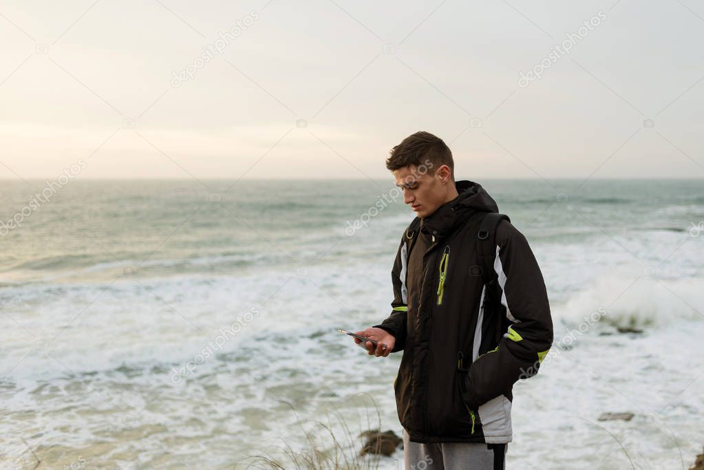the guy is clapping a phone against the sea